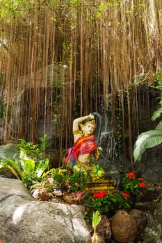 Sculpture in bushes. Golden mount (Wat Saket), Bangkok, Thailand.