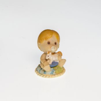 Miniature depicting a child holding a small toy horse in his hands