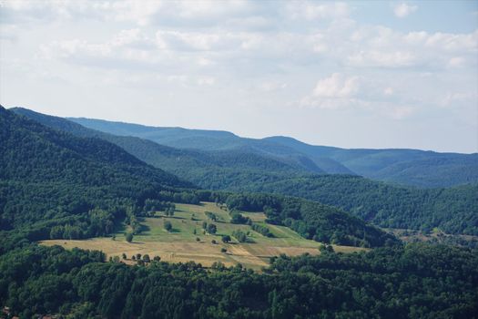 View over fields in the hilly terrain of Palatinate forest, Germany