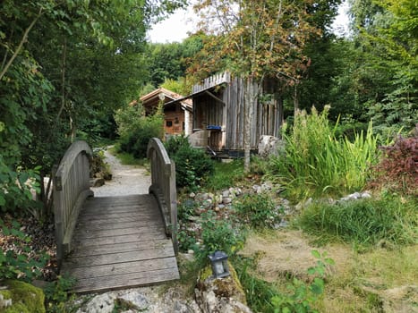 Tranquil garden with wooden bridge and wooden house