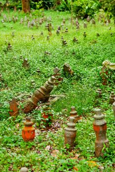 Graveyard with small monuments among grass. Cemetery in Singapore.