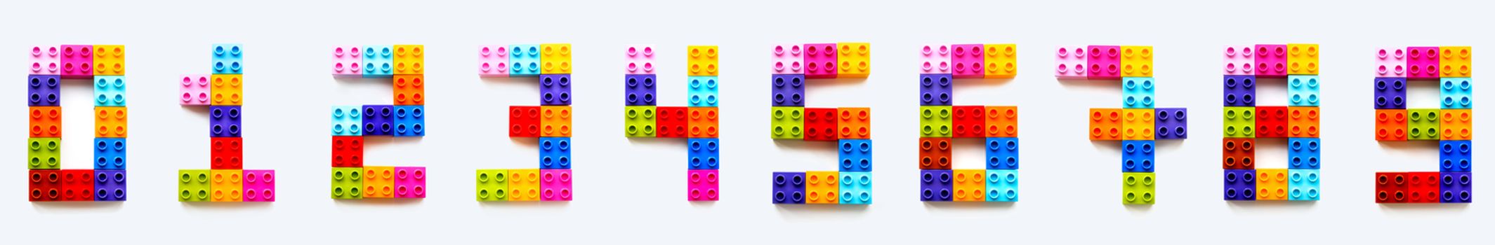Set of numbers from 0 to 9 made of colorful constructor blocks. Toy bricks lying in order from zero to nine. Education process - learning numbers with child using multicolored toy details.
