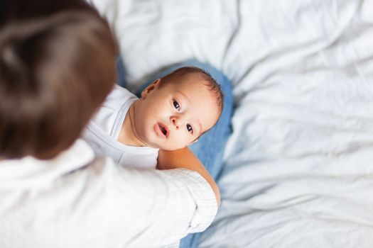 Woman holding her child. Mother comforts her little son or daughter.