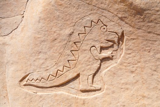 Funny dinosaur carved into the rock near St Julian's, Malta.