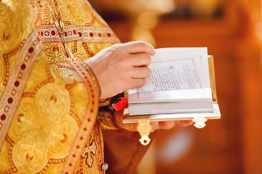 Prayer book in the hands of the priest. Ceremony in the Orthodox Christian Church. Russia.