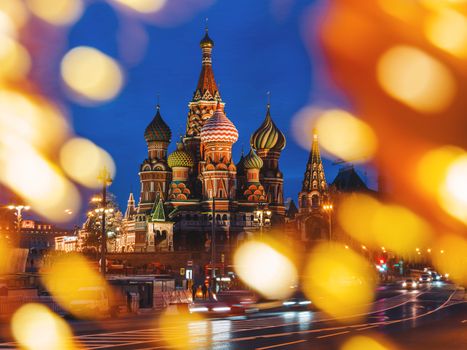 Famous landmark - St. Basil Cathedral on Red square in Kremlin. Light bulbs bokeh. Moscow, Russia.