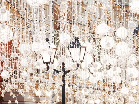 Famous Nikolskaya street decorated with light bulbs. Moscow, Russia.