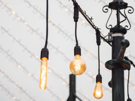Vintage light bulbs with glower filament. Incandescent retro design. Outdoor decoration for New Year and Christmas celebration. Moscow, Russia.