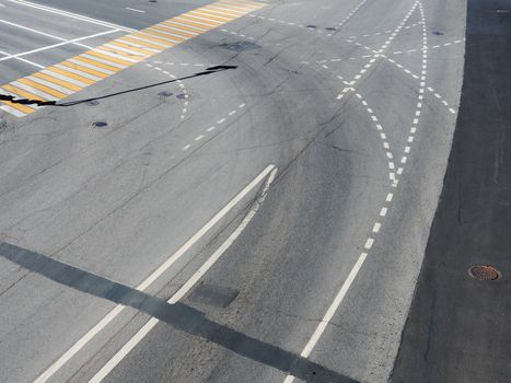 Road markings on the asphalt. Painted signs on the roadway and pedestrian crosswalk. Dotted line and arrows. Moscow, Russia.