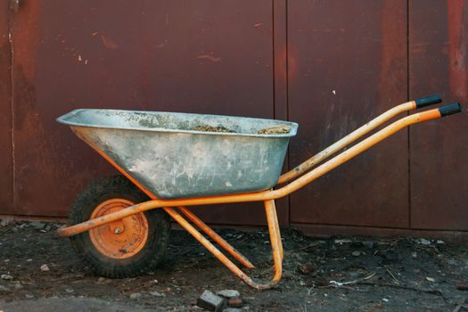 Cart for garbage removal stands at the construction site.
