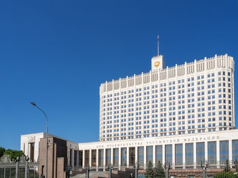 House of the Government of Russian Federation (White House). Russian Government House with flag. Famous state building against clear blue sky. Moscow, Russia.