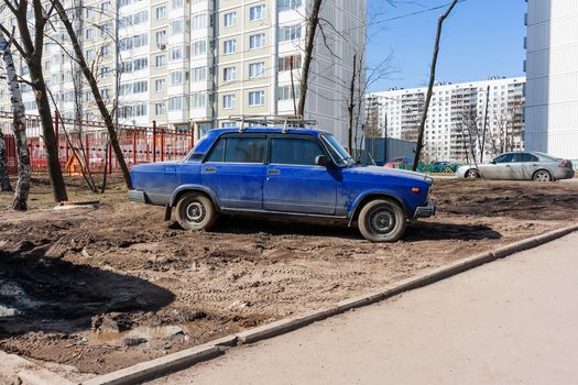Drivers parked their cars on the lawn. People are breaking parking rules. Moscow, Russia.