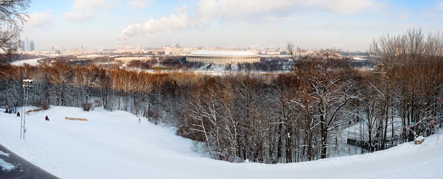 Panorama view on Luzhniki stadium and Sparrow Hills from observation deck near Moscow State Univercity (MSU). Aerial cityscape in winter sunny day. Moscow, Russia.