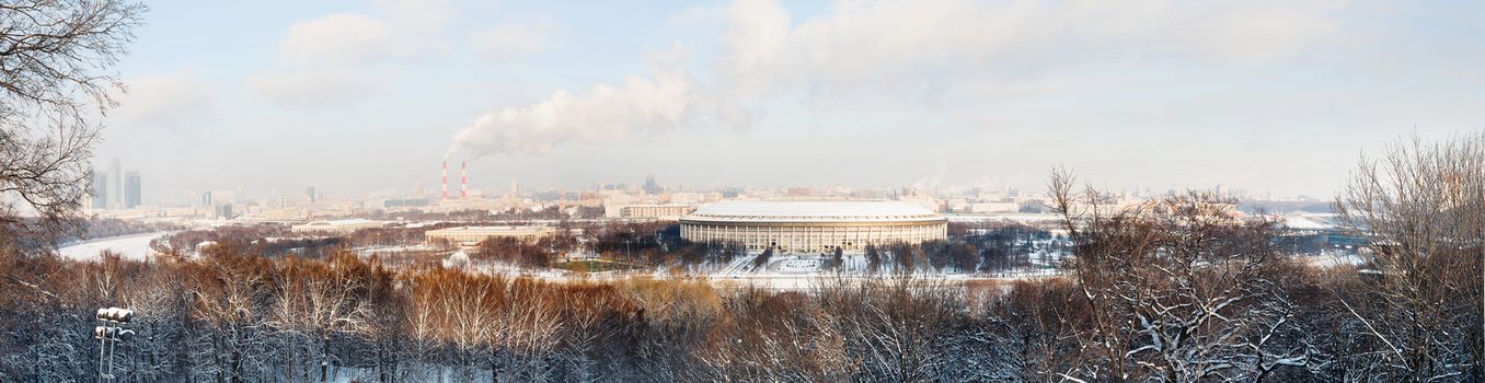 Panorama view on Luzhniki stadium and Sparrow Hills from observation deck near Moscow State Univercity (MSU). Winter sunny day. Moscow, Russia.