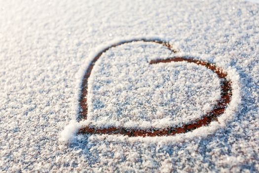 Heart drawn in snow. Symbol of love.