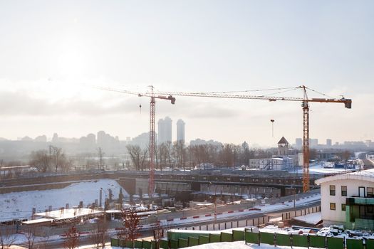 Construction near Poklonnaya Hill (Victory Park) in Moscow, Russia. Two cranes in winter sunny day.