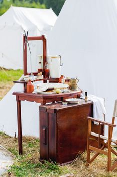 Old fashioned barber portable set - mirror, rowan tincture, razor, shaving brush, jar with water, nippers for moustaches, oil and ointments. Historical reconstruction of 19th century.