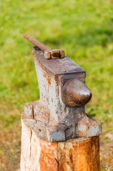 Hammer on the portable anvil. Old fashioned blacksmith tools in forge. Historical reconstruction of 19 century.