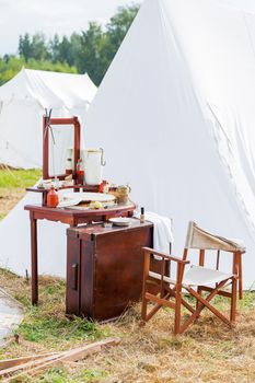 Old fashioned barber portable set - mirror, rowan tincture, razor, shaving brush, jar with water, nippers for moustaches, oil and ointments. Historical reconstruction of 19th century.