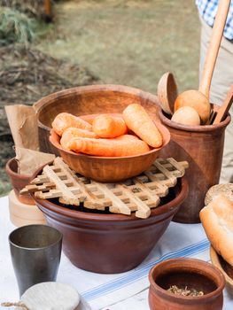 Vintage dinnerware, earthenware crockery and old fashioned household items on historical festival Times and Epochs. Moscow, Russia.