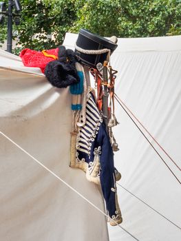 Old fashioned military hussar's uniform and hat on annual festival Times and Epochs. Historical reconstruction. Moscow, Russia.