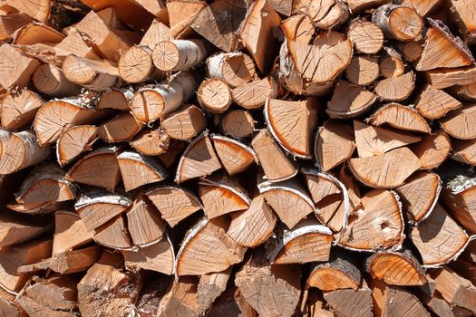 Rural abstract background with stack of firewood.Chopped wood stacked in pile.
