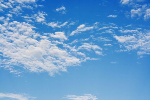 Bright sunny day with clouds. Cloudscape on blue sky. Soft focus.