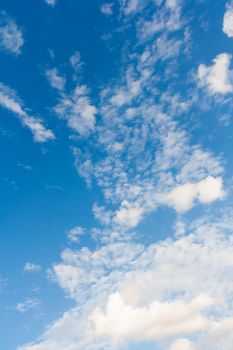 Bright sunny day with clouds. Cloudscape on blue sky. Soft focus.