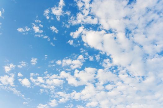 Bright sunny day with clouds. Cloudscape on blue sky. Soft focus.