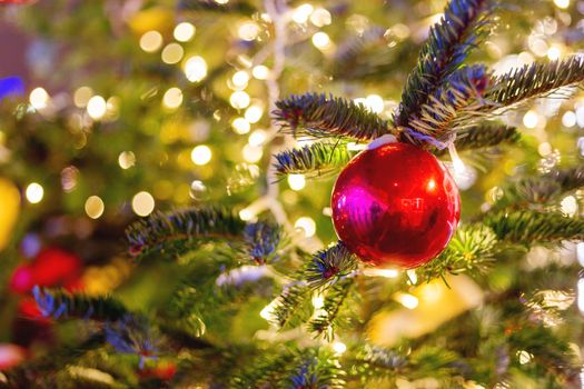 Streets decorated for New Year and Christmas celebration. Tree with bright red and yellow balls. Moscow, Russia.