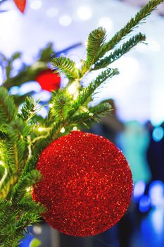 Streets decorated for New Year and Christmas celebration. Tree with bright red and yellow balls. Moscow, Russia.