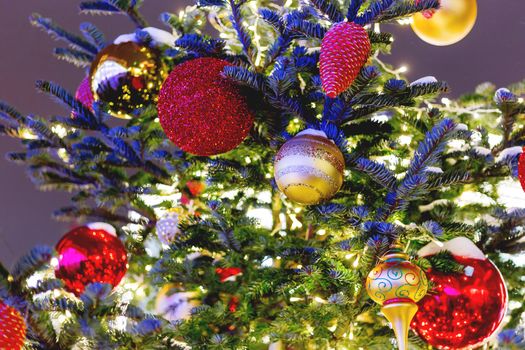 Streets decorated for New Year and Christmas celebration. Tree with bright red and yellow balls. Moscow, Russia.
