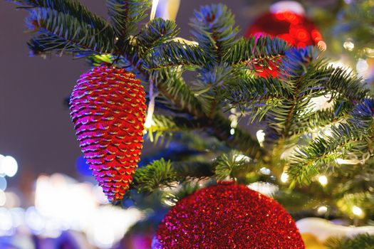 Streets decorated for New Year and Christmas celebration. Tree with bright red and yellow balls. Moscow, Russia.