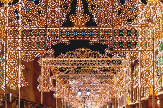 Streets of Moscow decorated for New Year and Christmas celebration. Buildings with light bulbs. Russia.