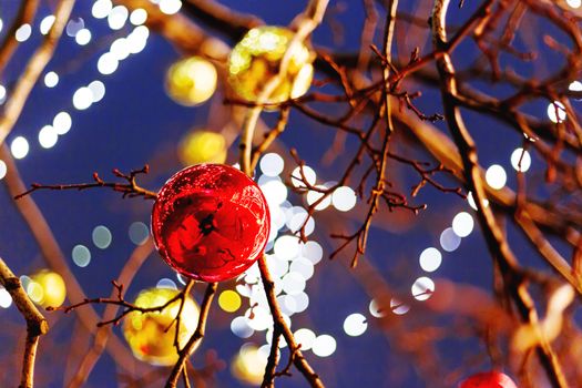 Streets of Moscow decorated for New Year and Christmas celebration. Tree with bright red and yellow balls. Russia.