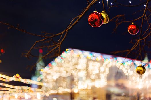 Streets of Moscow decorated for New Year and Christmas celebration. Tree with bright red and yellow balls. Russia.