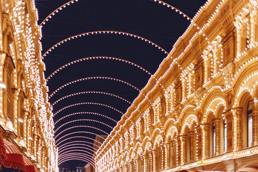 Vetoshny lane decorated with light bulbs for Christmas and New Year celebration. GUM (Main department Store). Russia.