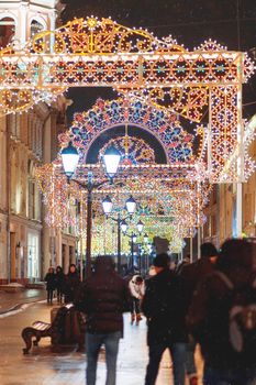 Streets of Moscow decorated for New Year and Christmas celebration. Buildings with light bulbs. Russia.