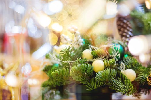 Christmas wreath made with pine and fir branches, white balls. Hand made New Year decoration with light bulbs.