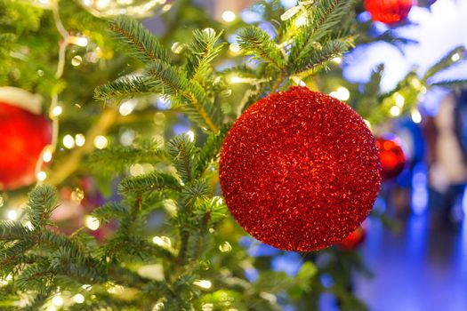 Streets decorated for New Year and Christmas celebration. Tree with bright red and yellow balls. Moscow, Russia.