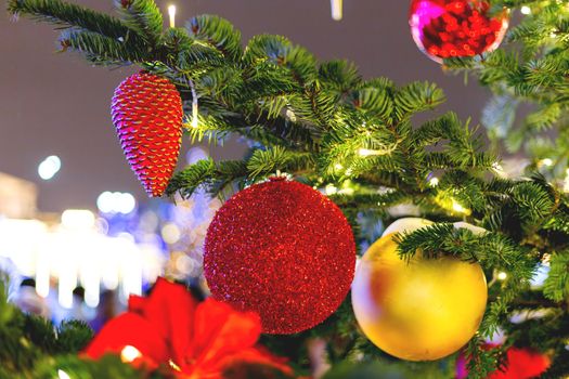 Streets decorated for New Year and Christmas celebration. Tree with bright red and yellow balls. Moscow, Russia.