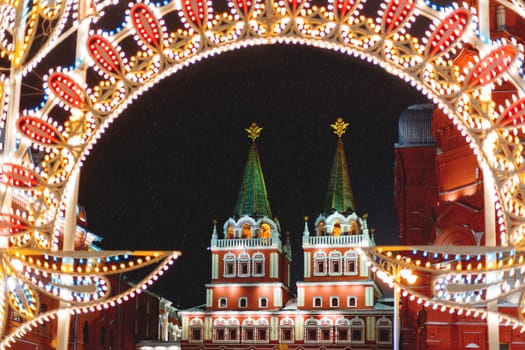 Historic center of Moscow decorated to New Year and Christmas celebration. Resurrection gate, entrance on Red Square. Winter snowy evening. Russia.