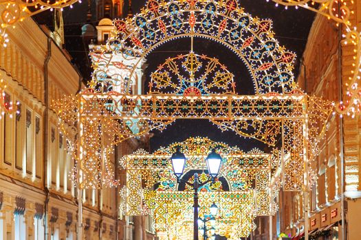 Streets of Moscow decorated for New Year and Christmas celebration. Buildings with light bulbs. Russia.
