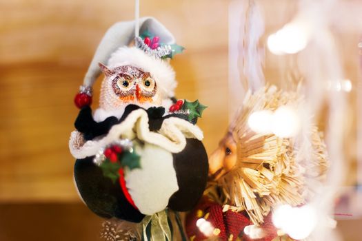 Christmas and New Year background with bright decorative balls and owl in Santa Claus hat. Decorations for celebration.