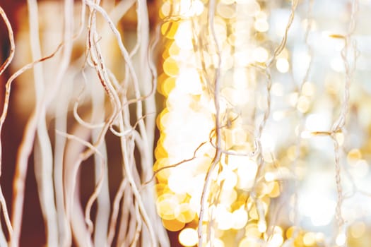 Defocused night street lights, blurred colorful bokeh background. Holiday colorful lanterns and light bulbs garlands.