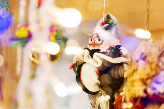 Christmas and New Year background with bright decorative balls and owl in Santa Claus hat. Decorations for celebration.