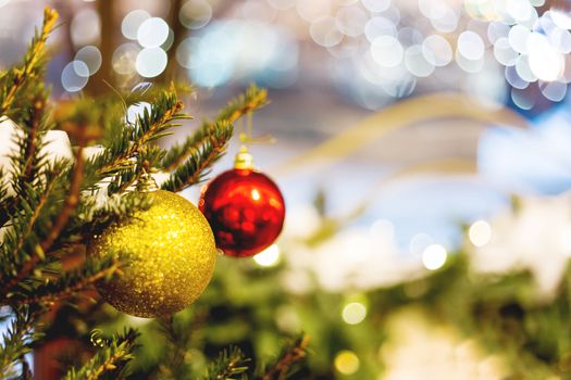 Streets decorated for New Year and Christmas celebration. Tree with bright red and yellow balls. Place for text.