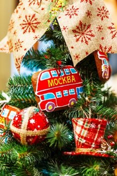 Fir tree decorated with gingerbread in shape of double decker bus (with word Moscow) and fabric balls for Christmas and New Year celebration. Moscow, Russia.