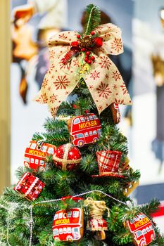 Fir tree decorated with gingerbread in shape of double decker bus (with word Moscow) and fabric balls for Christmas and New Year celebration. Moscow, Russia.