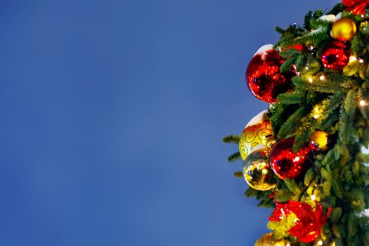 Outdoor decorations for New Year and Christmas celebration. Streets decorated with light bulbs and colorful shiny balls. Place for text.
